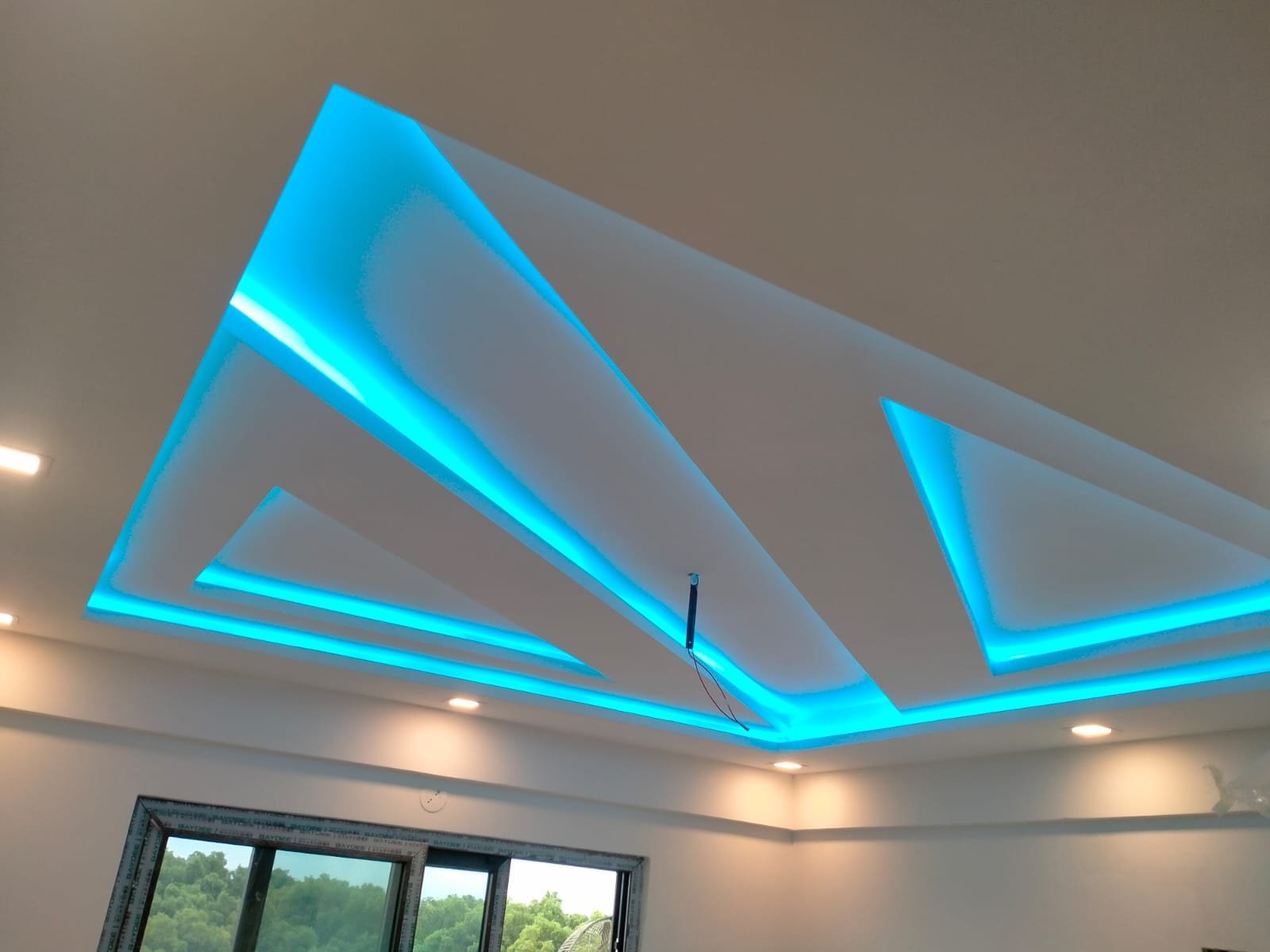 Layered multi-height POP ceiling with geometric cove lighting